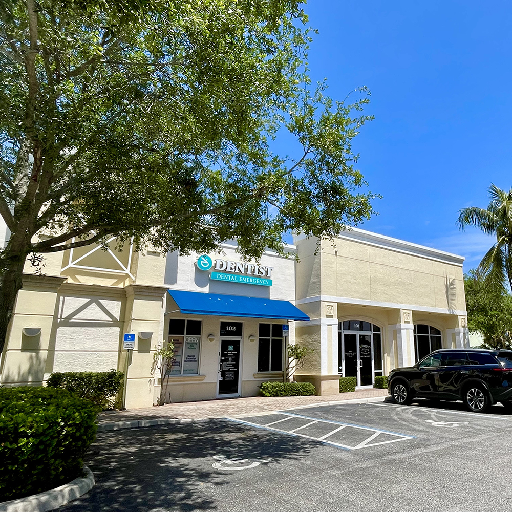 The image depicts a modern dental clinic with a blue awning, situated in a sunny, suburban area with palm trees and clear skies.